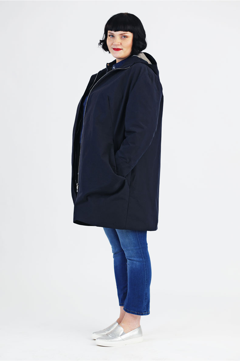 Diagonally to the camera, a woman is standing in her self-sewn parka named Amy.